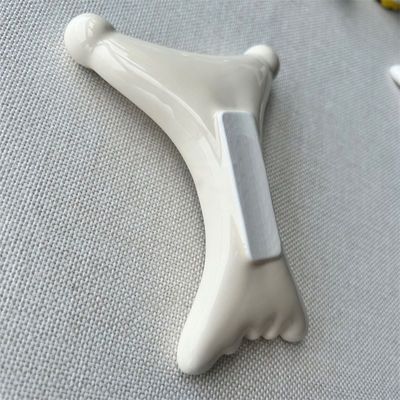OEM/ODM Ceramique en forme de X Gua Sha Scraping Massageur Salon de beauté Essentiel pour la relaxation du visage